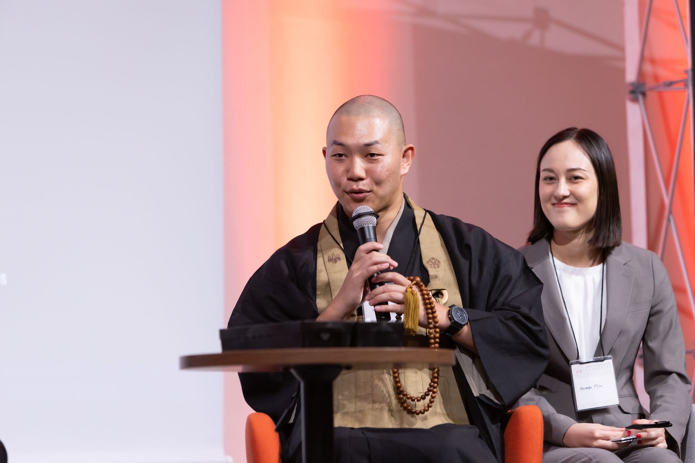 A Buddhist monk speaking during a panel