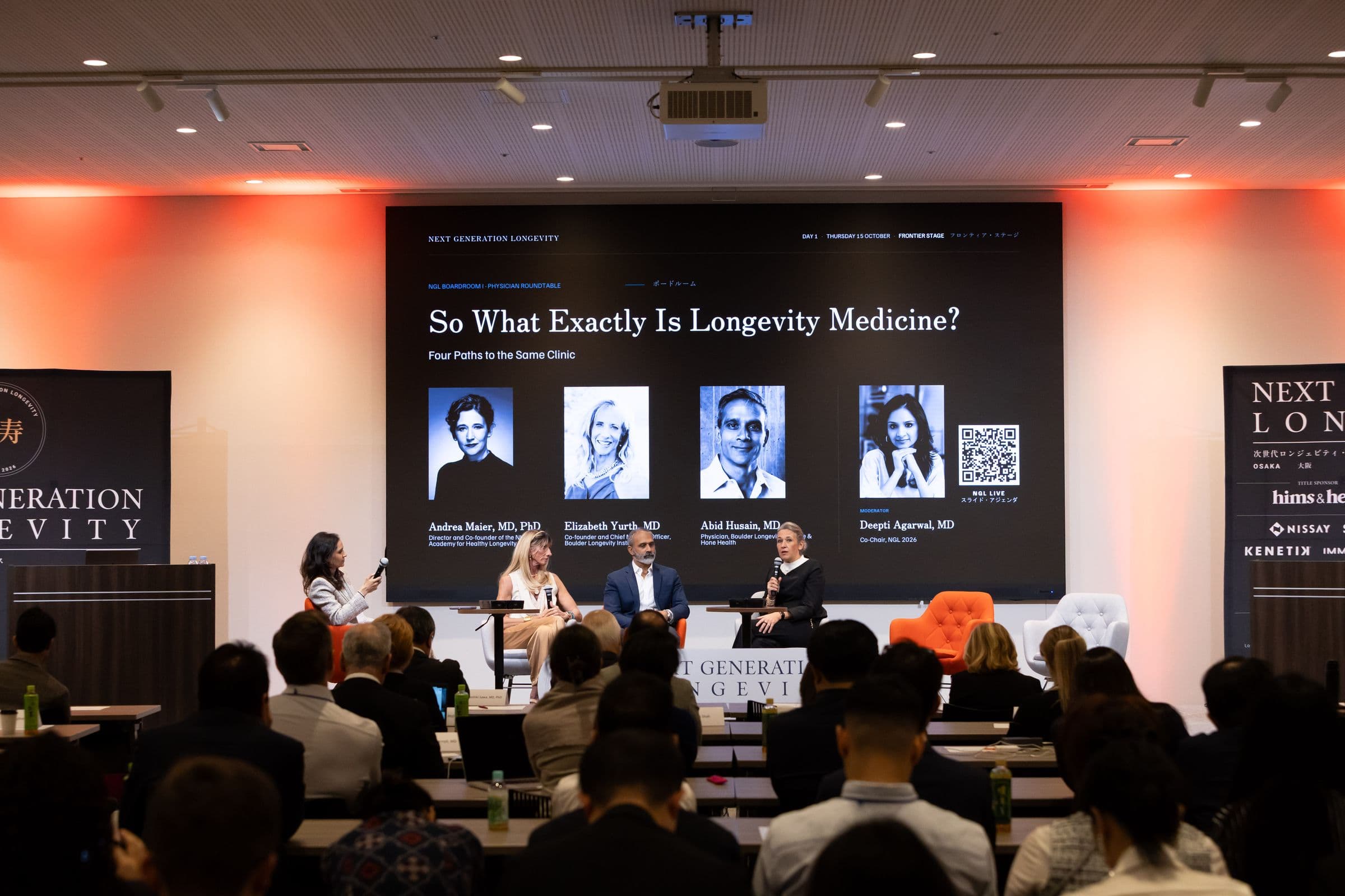 Physician roundtable on stage in front of a full audience