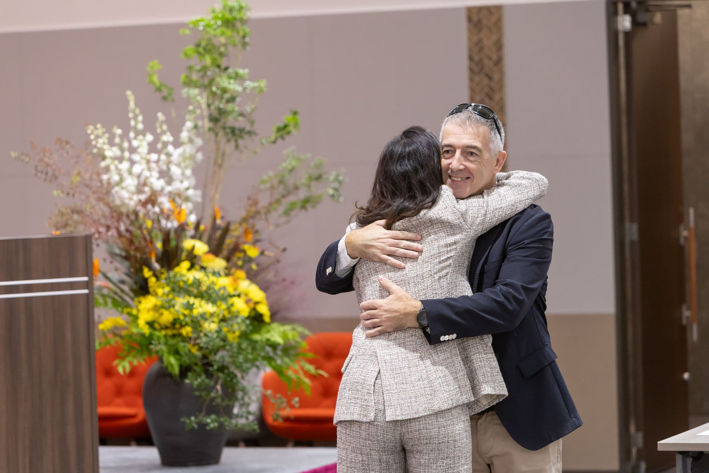 Two guests embracing as they arrive on Day 1